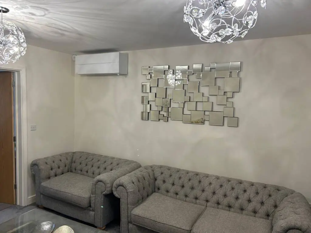 a couches and a mirror on the wall