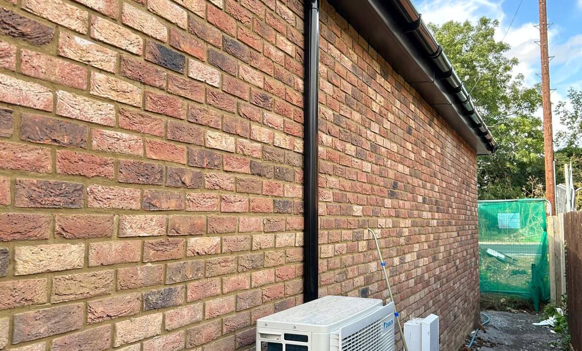 a brick wall with a white air conditioner