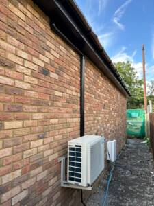 a brick wall with a white air conditioner