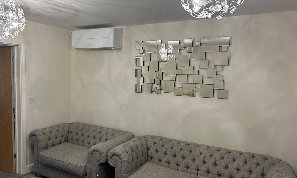 a couches and a mirror on the wall