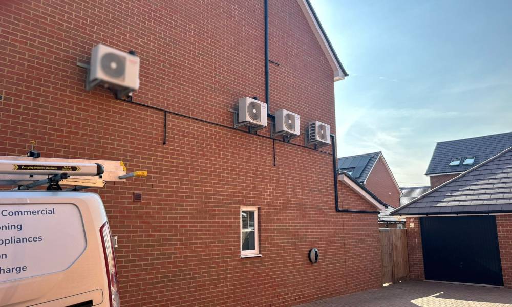 a brick building with air conditioning units on the side