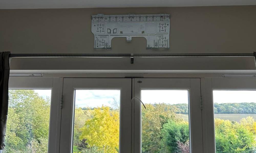 a sliding glass doors with a picture from the ceiling